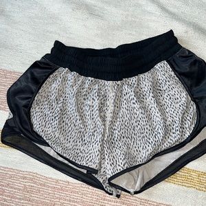 Size 6 Lululemon cream and black colored running shorts.